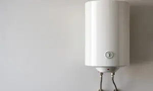 Biały bojler wiszący na ścianie. Zastanawiasz się, ile prądu zużywa piec gazowy dwufunkcyjny? To urządzenie jest kluczowe dla ogrzewania i ciepłej wody.